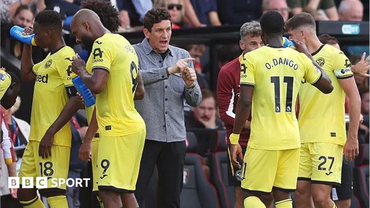 Manager instructing players during match break