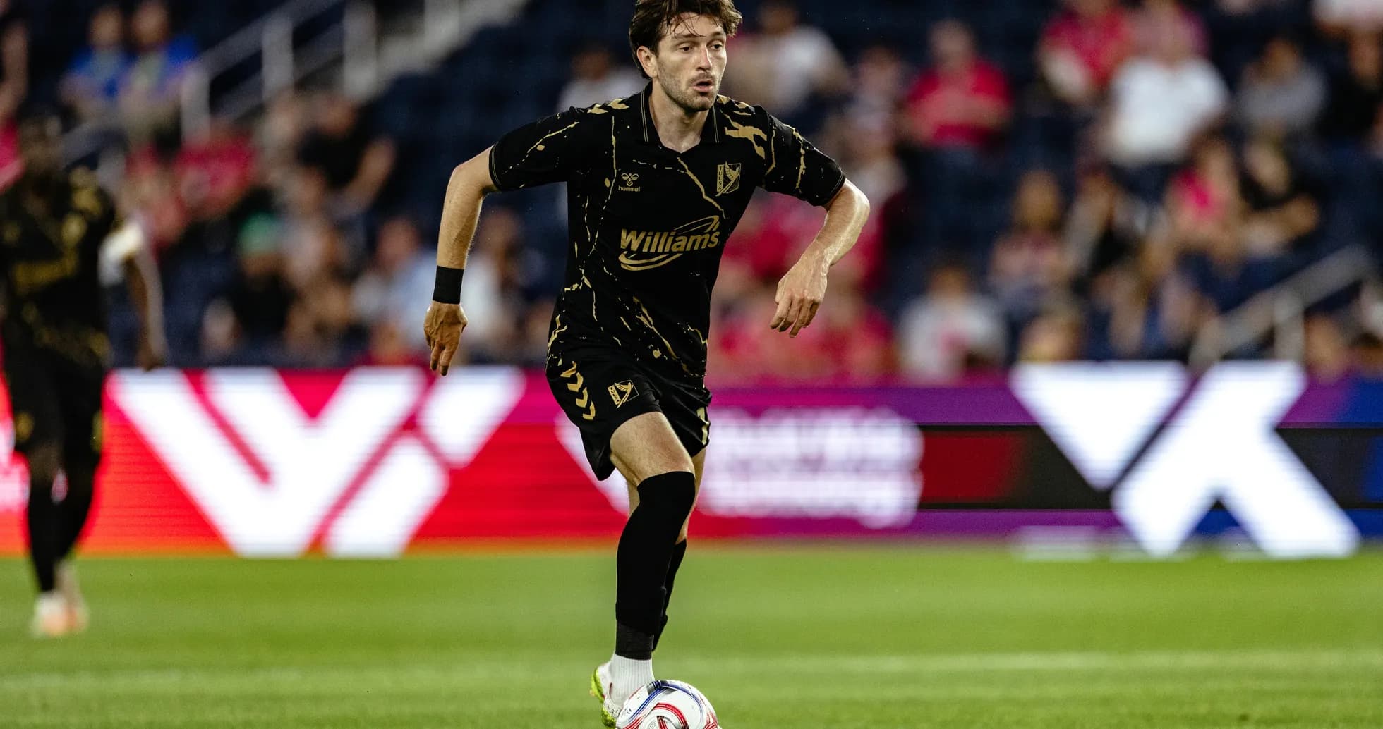 Player dribbling the ball during football match