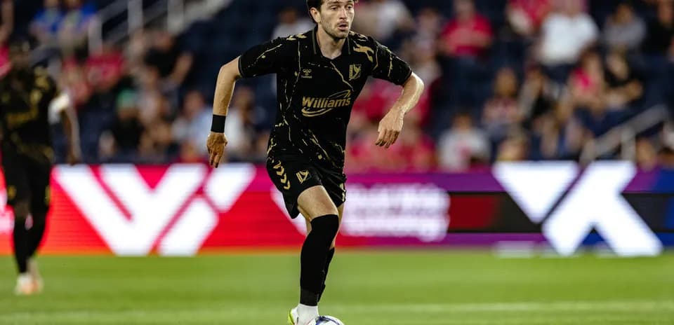 Player dribbling the ball during football match
