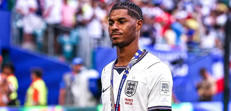 Player wearing England jersey with medal on field