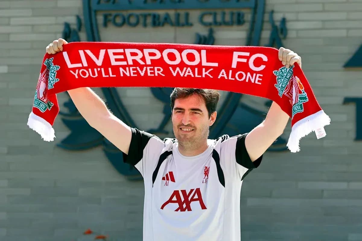 Person holding Liverpool FC scarf outside club building