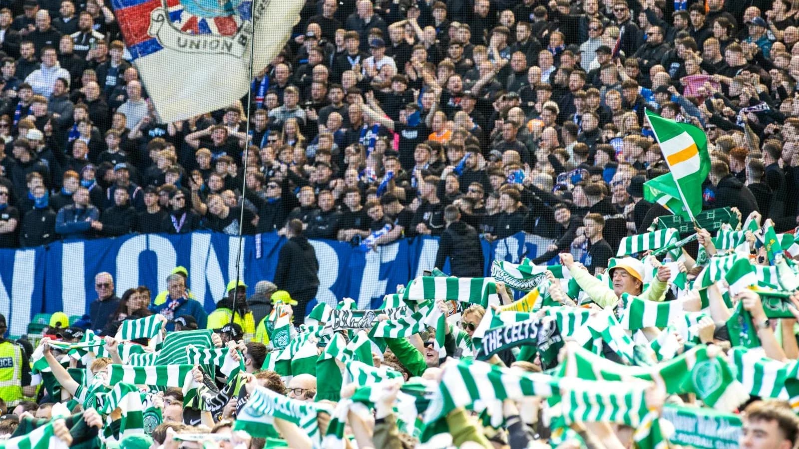Fans waving scarves in a crowded stadium