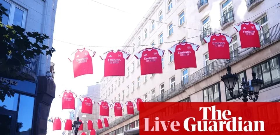 Red Arsenal jerseys hanging across a street