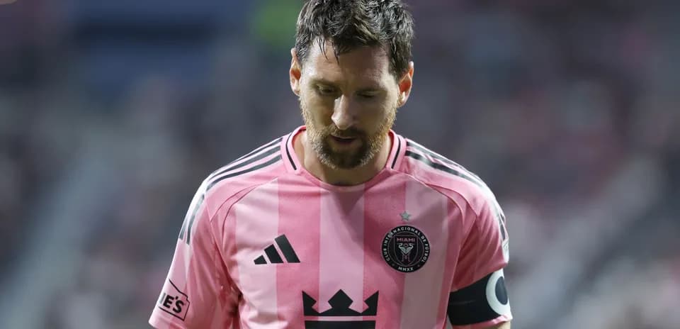 Player in pink jersey walking on field during match