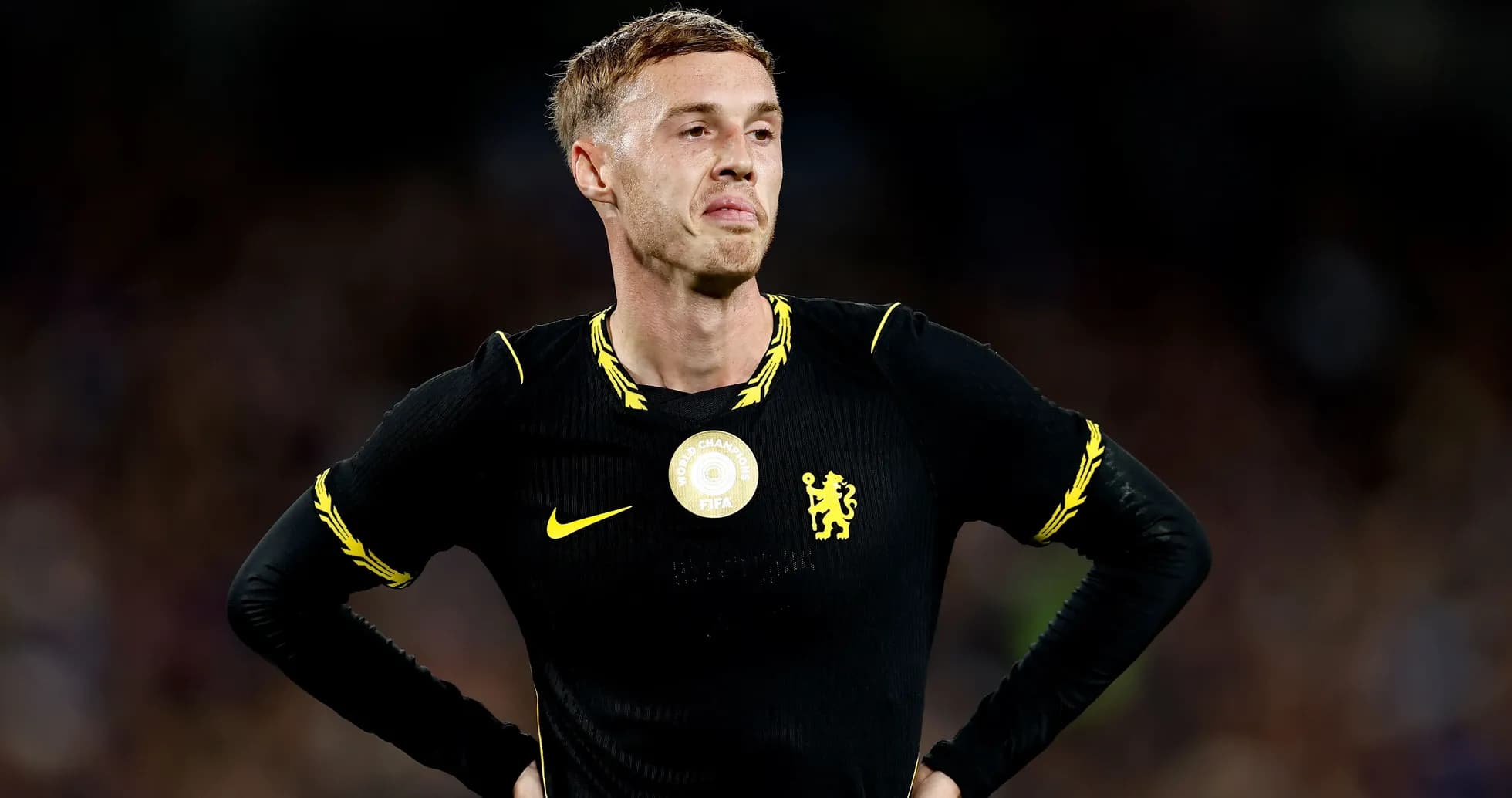 Player in black jersey with Chelsea logo on field