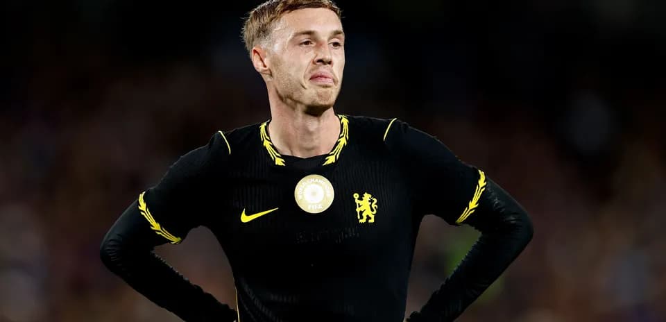 Player in black jersey with Chelsea logo on field