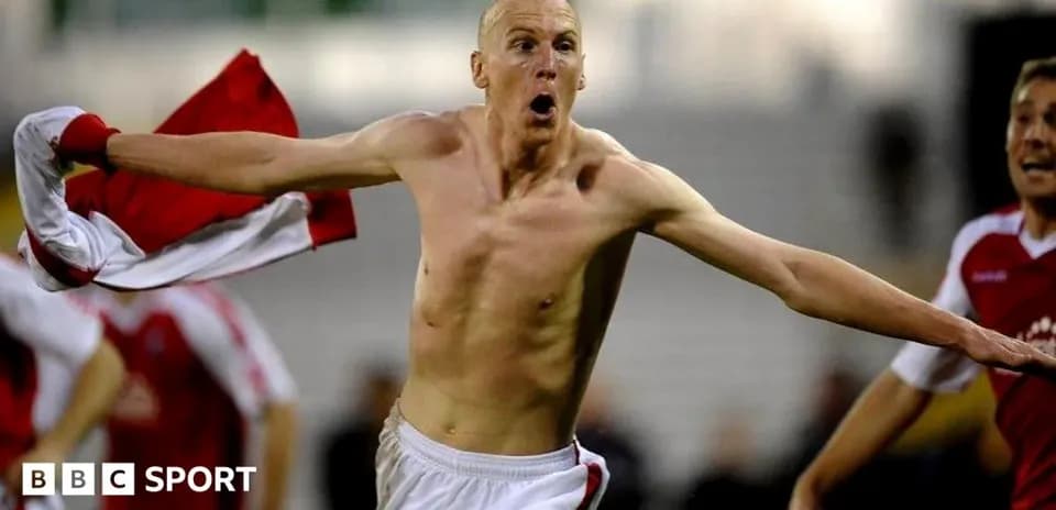 Player celebrating with shirt after scoring a goal