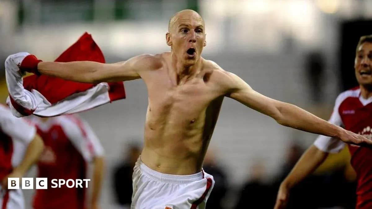Player celebrating with shirt after scoring a goal