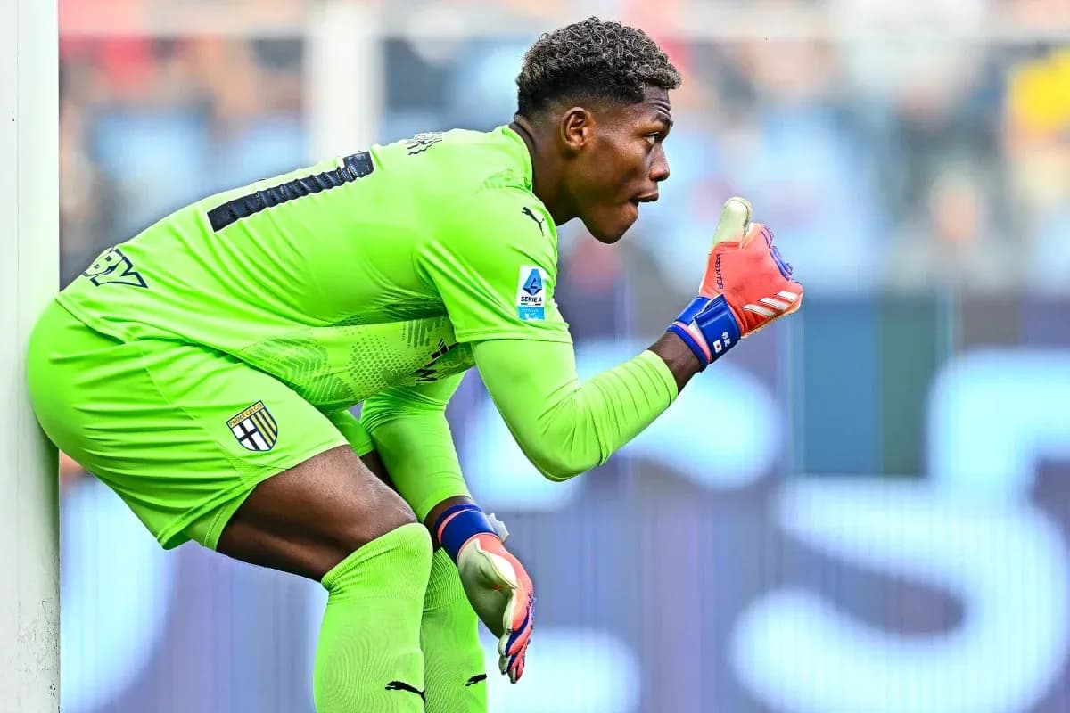 Goalkeeper in green kit signaling during match
