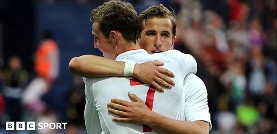 Two players hugging on the football pitch
