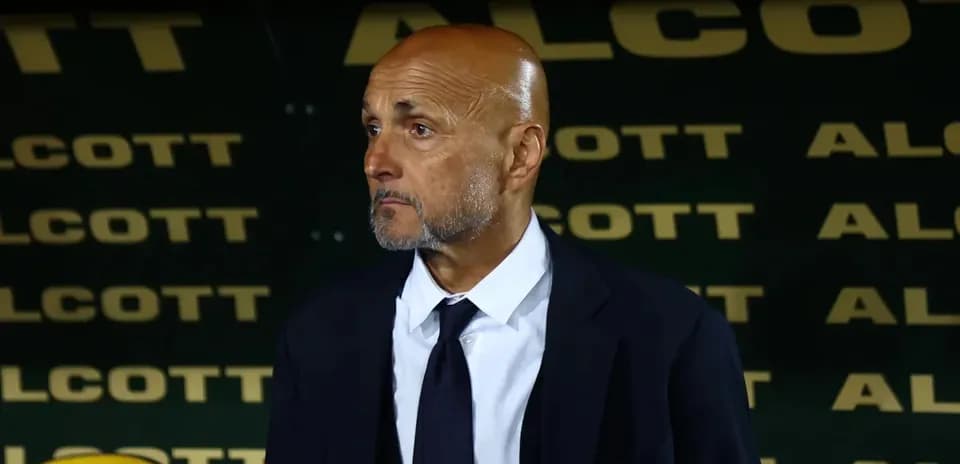 Coach standing in front of team bench during match