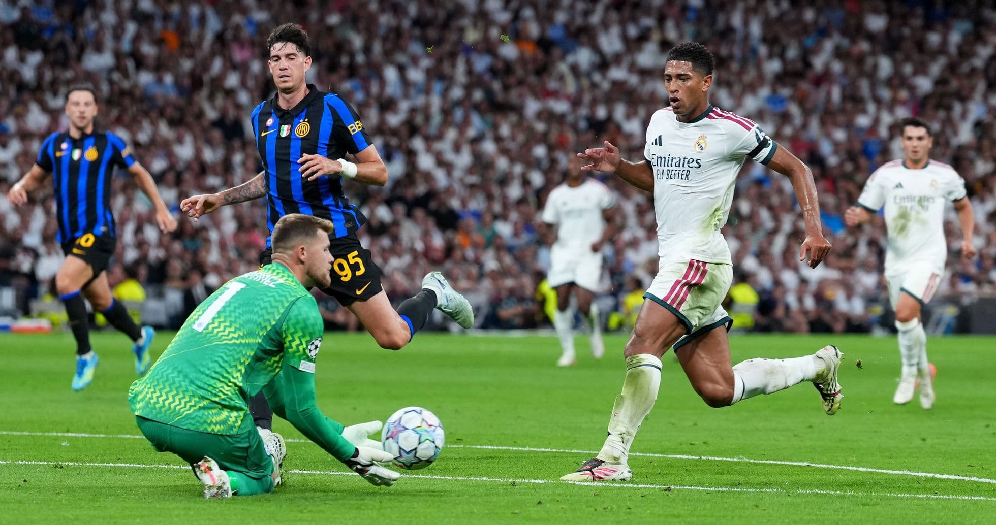 Player running past goalkeeper during UEFA Champions League match