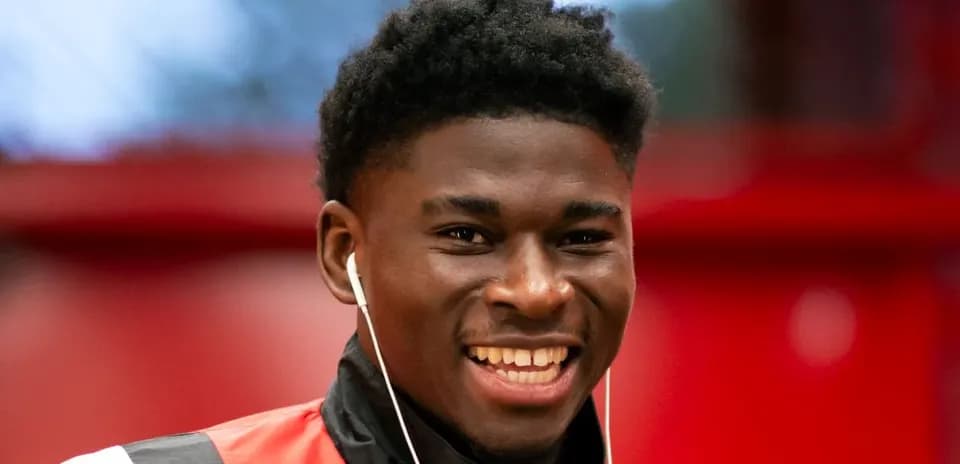 Player smiling while wearing headphones indoors
