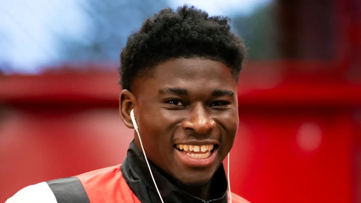 Player smiling while wearing headphones indoors