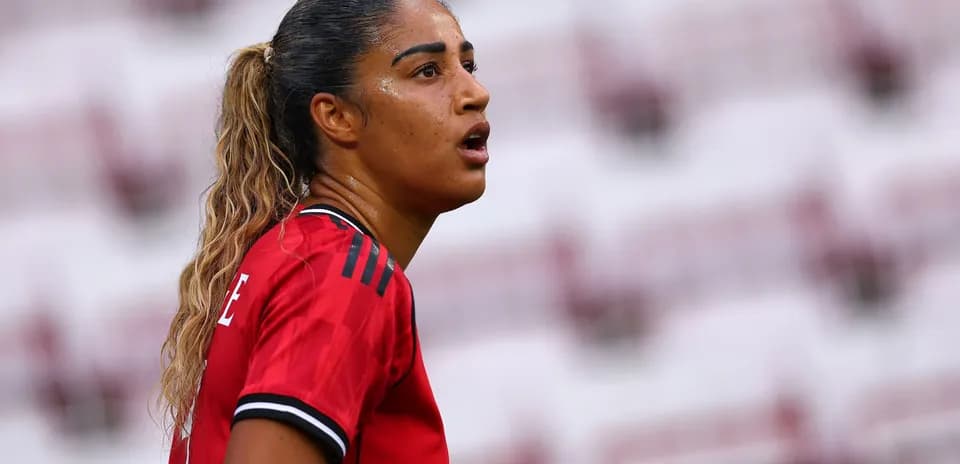 Player in red jersey looking during match