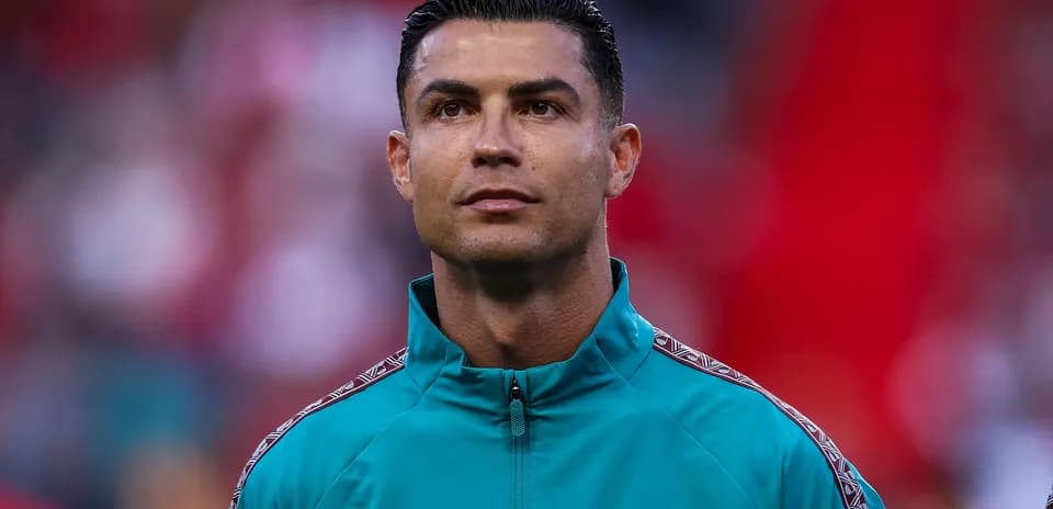 Player wearing teal jacket during match warm-up