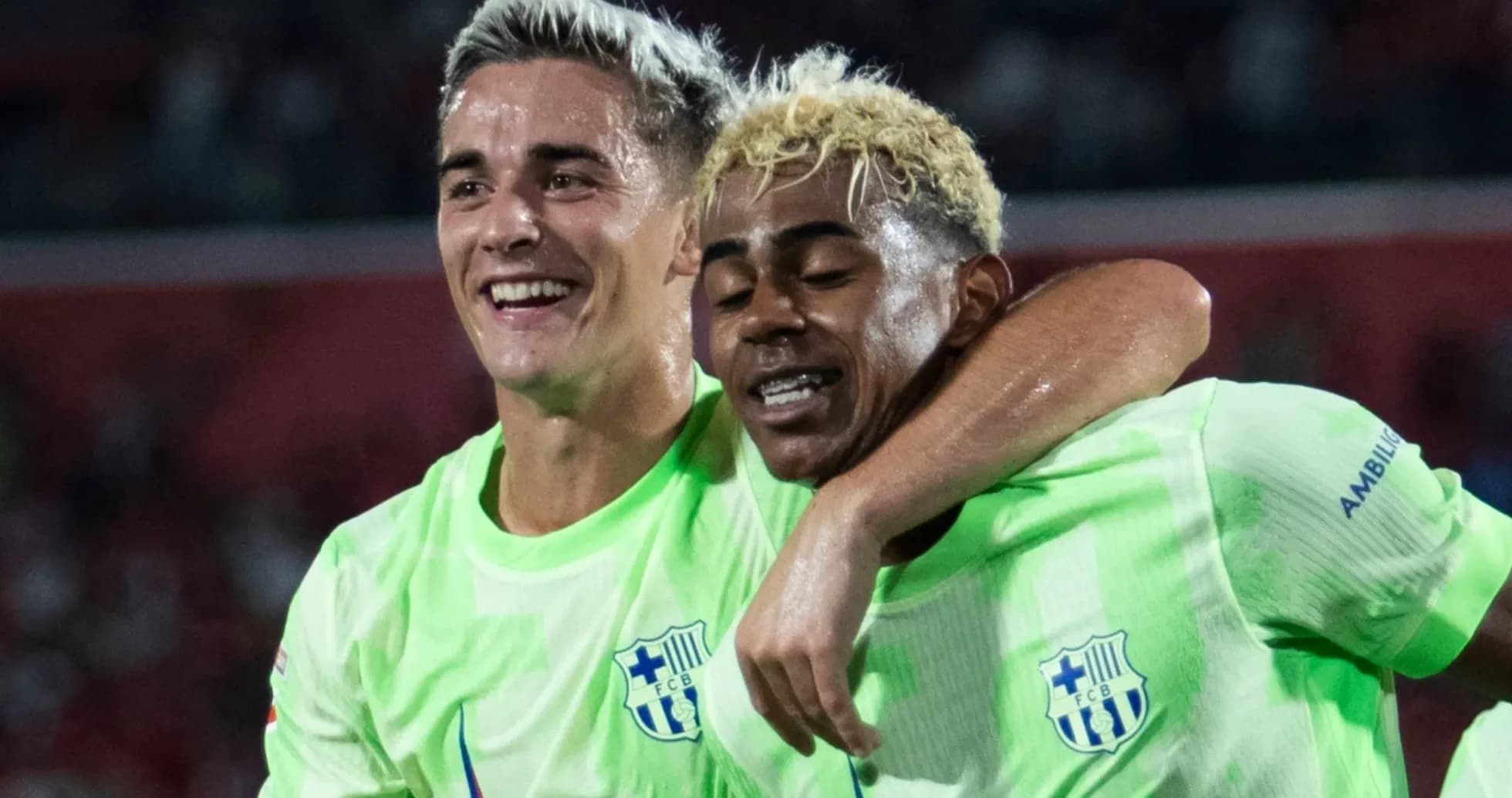 Two players celebrating together in green jerseys
