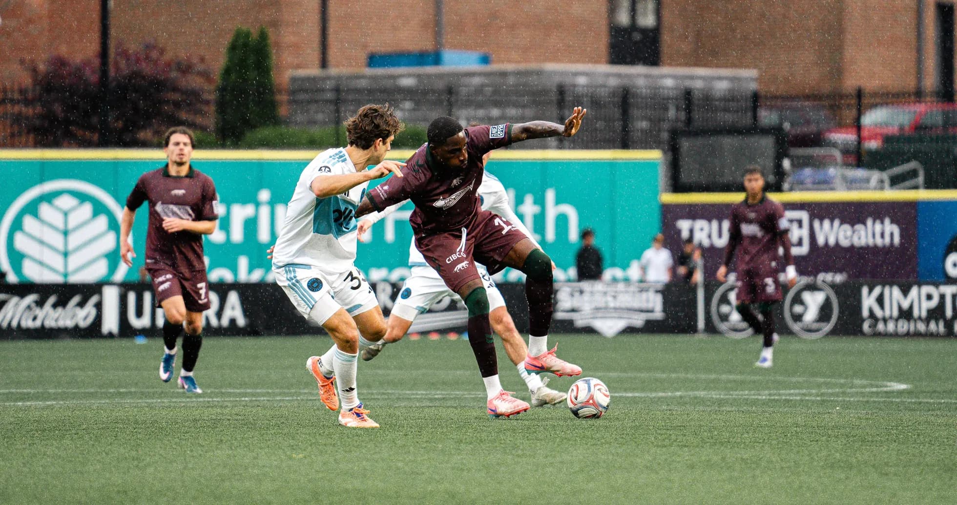 Players competing for the ball during MLS Next Pro match