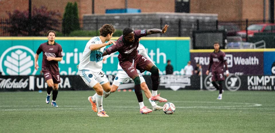 Players competing for the ball during MLS Next Pro match