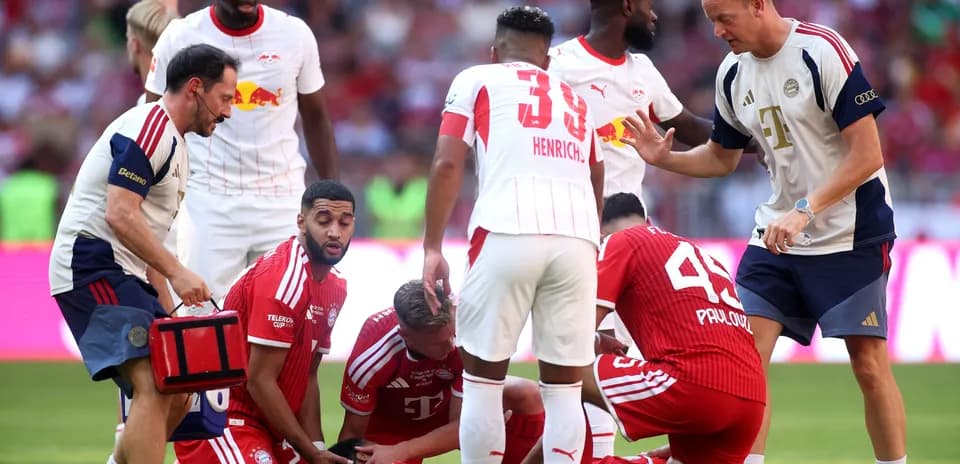 Players attending to an injured teammate on field