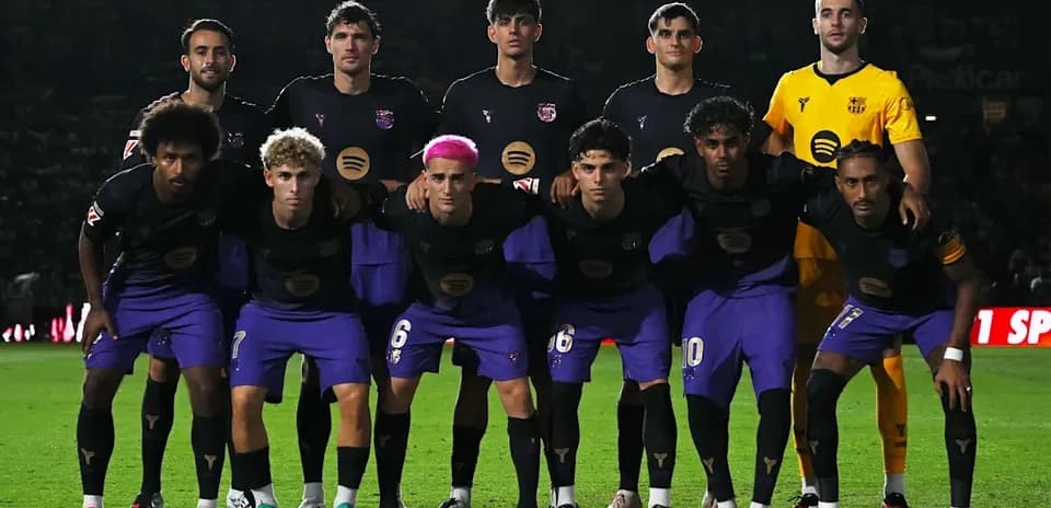 Football team posing for group photo on field