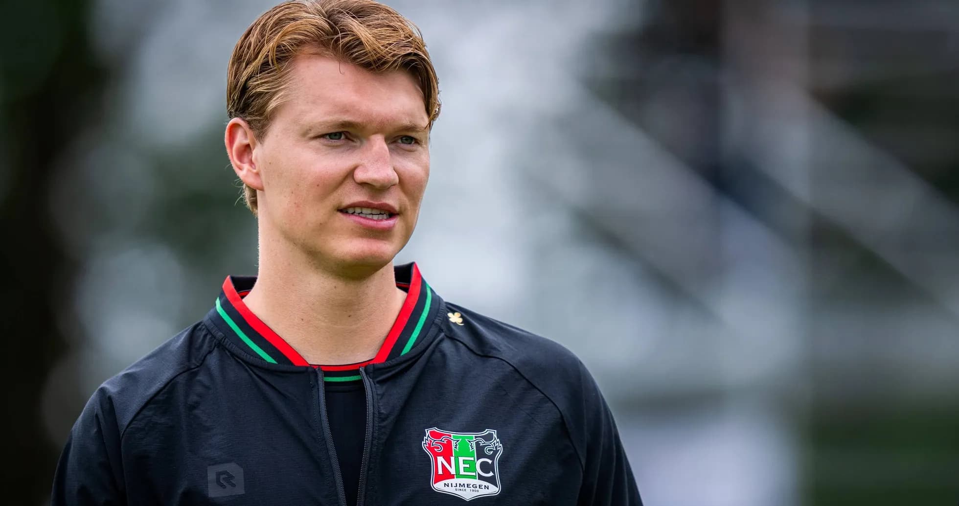 Player wearing NEC Nijmegen training jacket outdoors