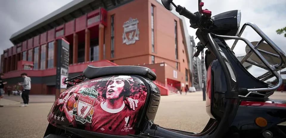 Scooter with Liverpool FC mural outside stadium