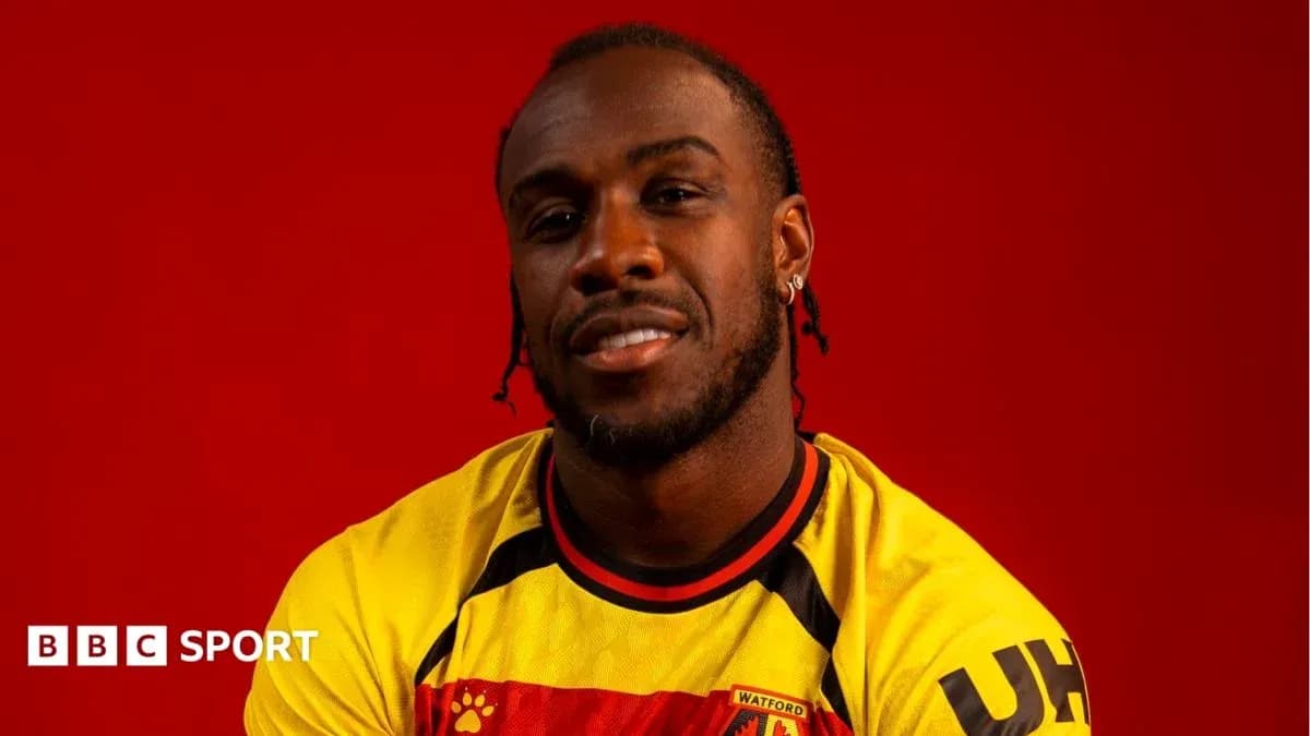 Player posing in Watford FC jersey against red background