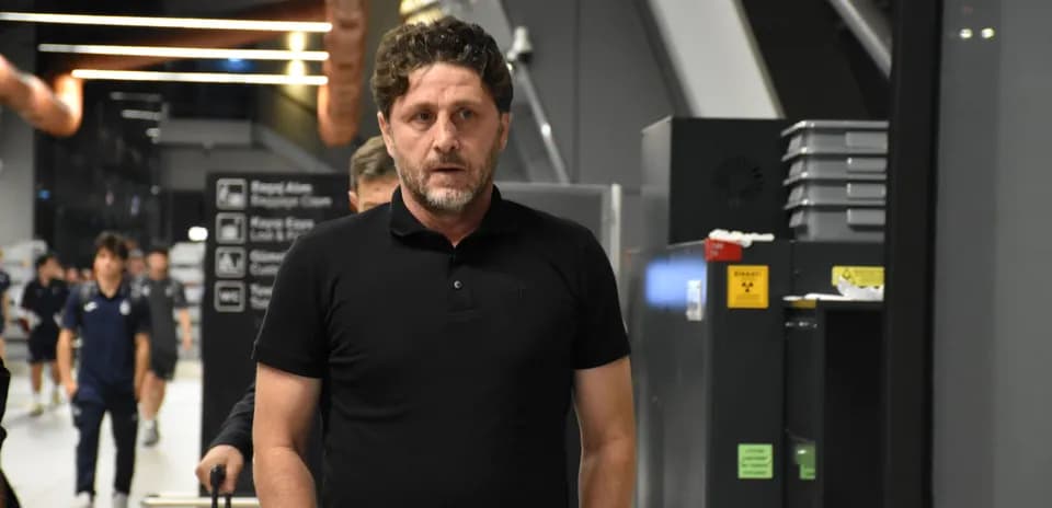 Man walking through airport terminal with luggage
