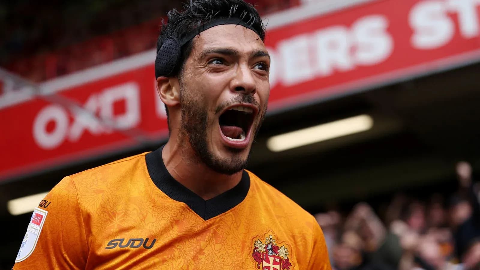 Player celebrating enthusiastically in orange jersey
