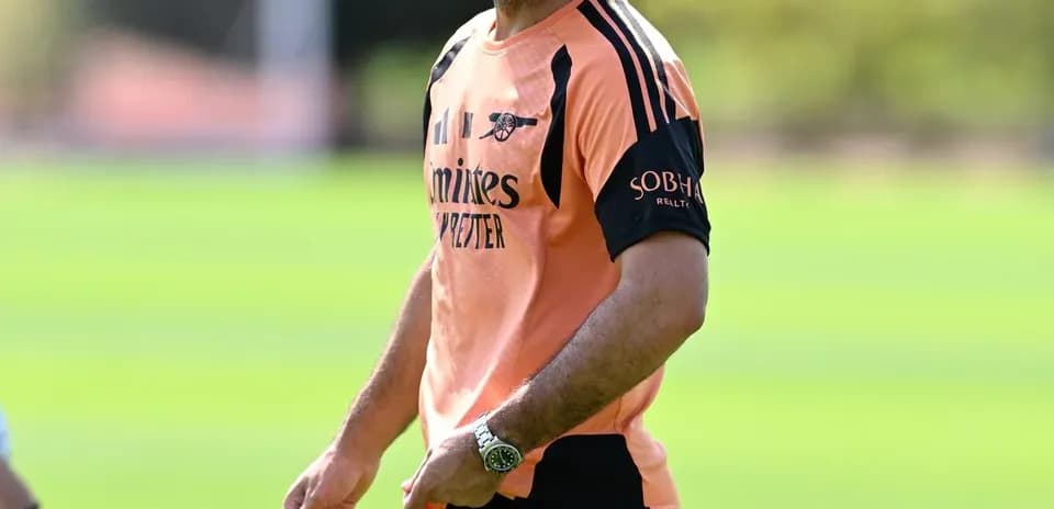 Arsenal manager during training session on pitch