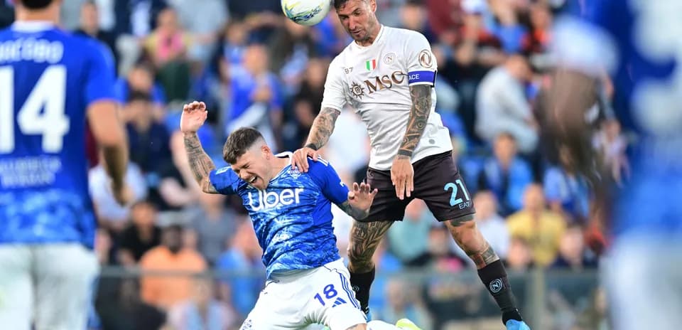 Napoli player challenging Como player during match