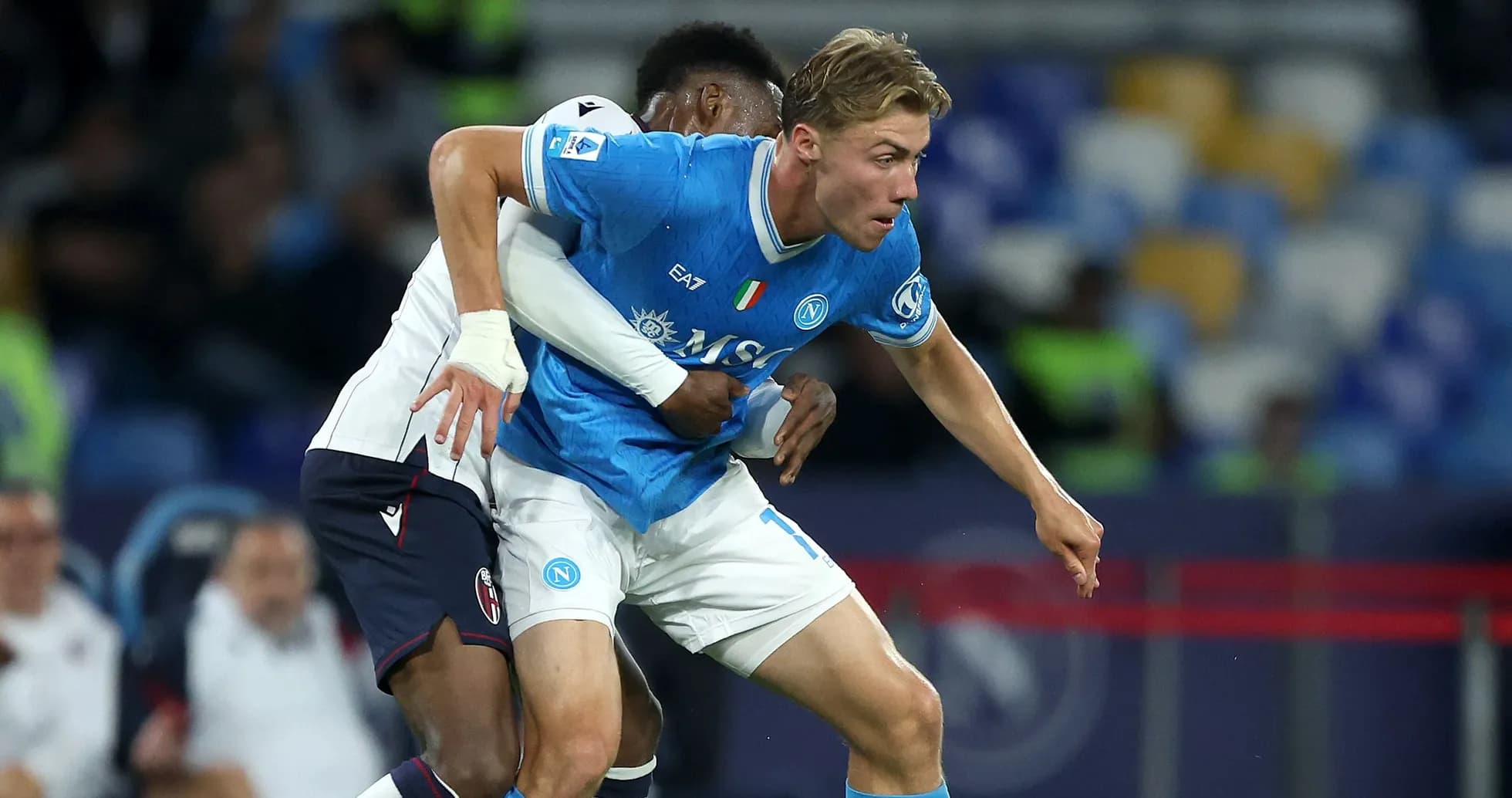 Napoli player being tackled during a match