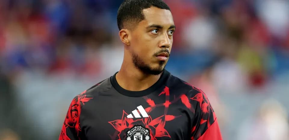 Player in Manchester United training kit on field
