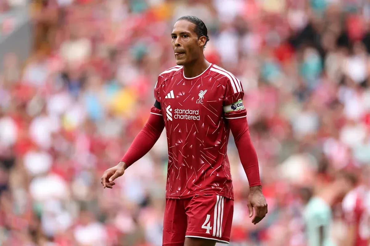 Player in red Liverpool kit walking on the pitch