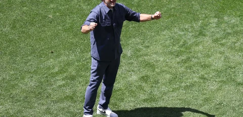 Coach celebrating on the field during a match