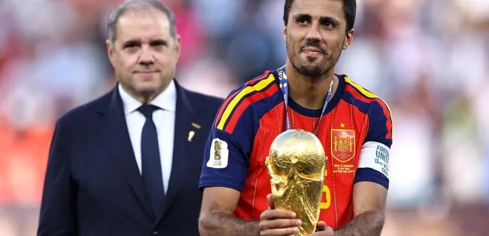 Player holding World Cup trophy with official present