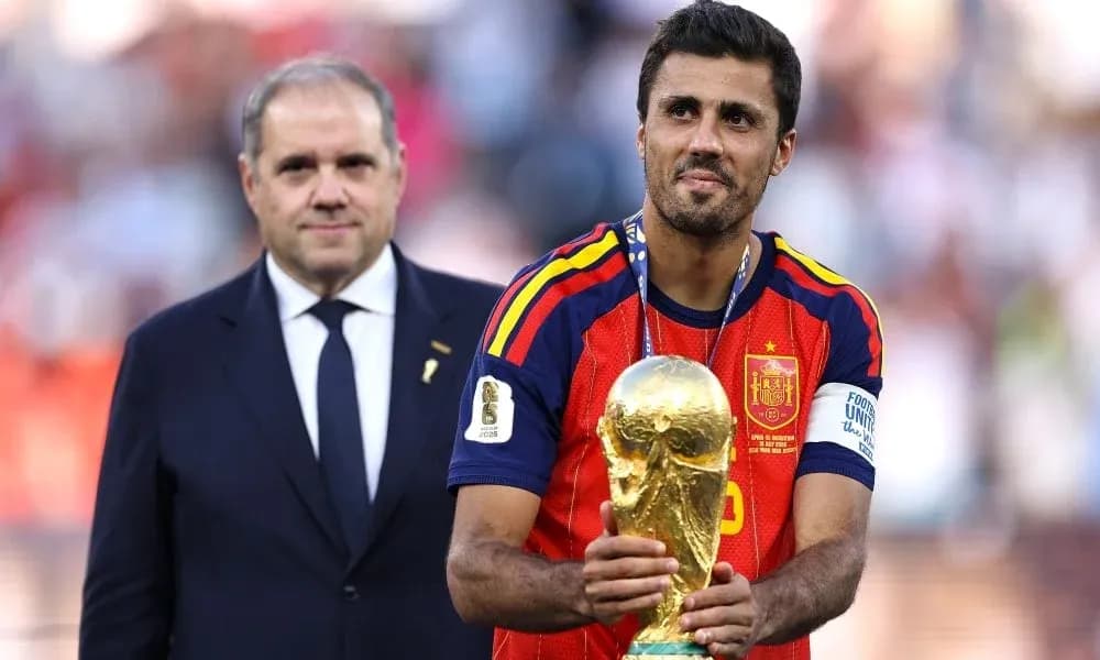 Player holding World Cup trophy with official present