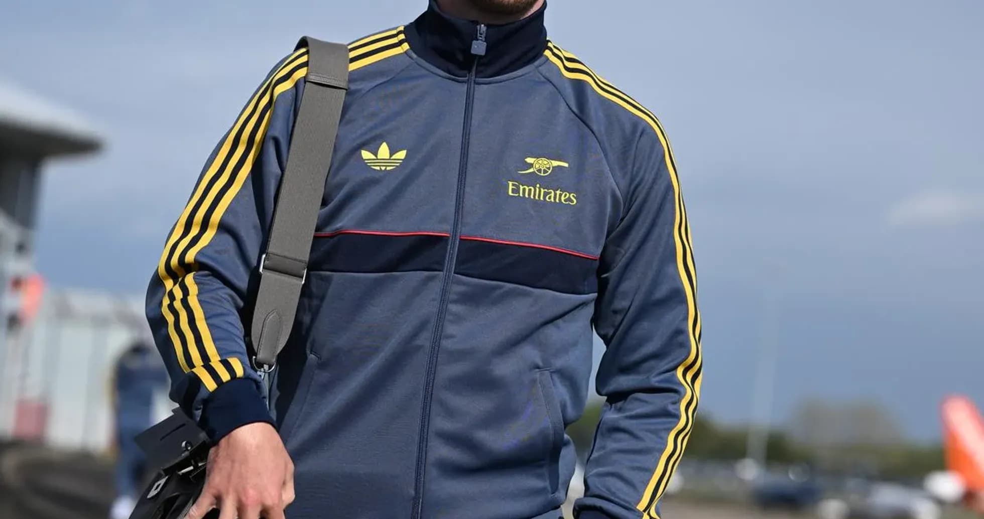 Person in athletic wear walking with a bag