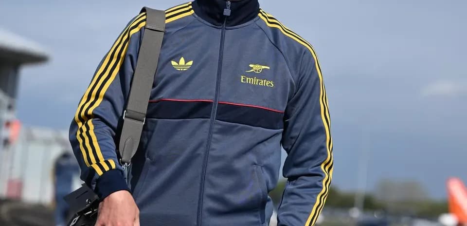 Person in athletic wear walking with a bag