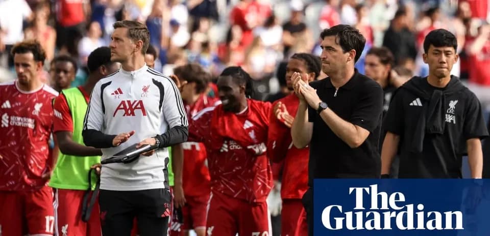 Liverpool players and staff walking off the pitch