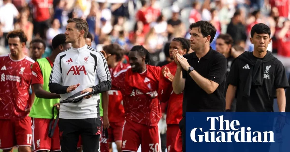 Liverpool players and staff walking off the pitch