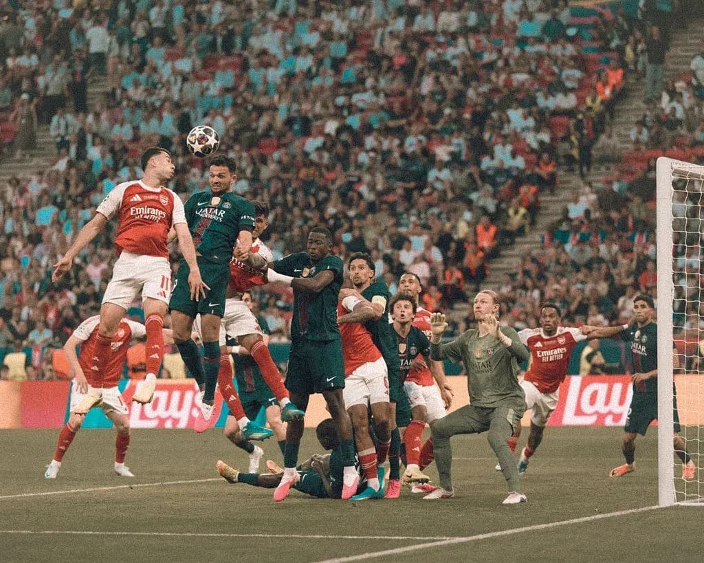 Players contesting a high ball in penalty area