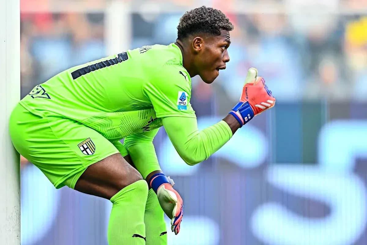 Goalkeeper in green kit signaling during match