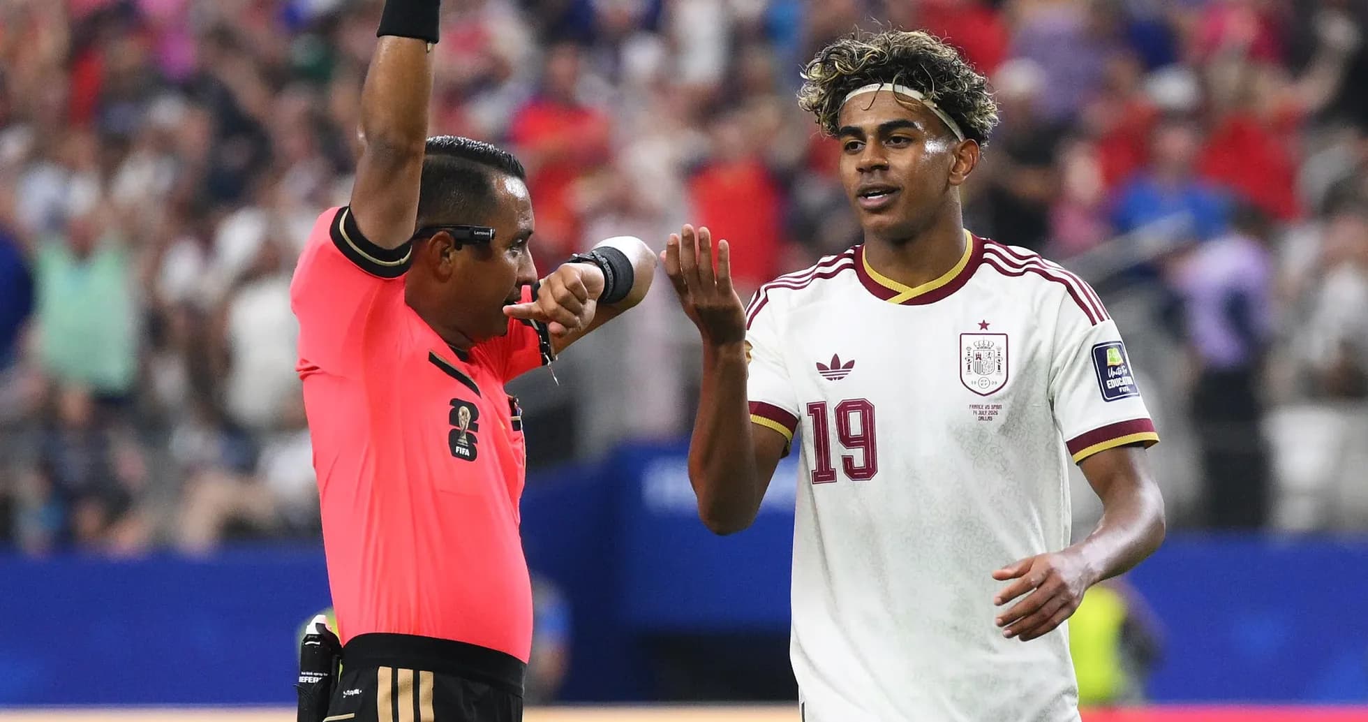 Referee showing a card to Spain player during match