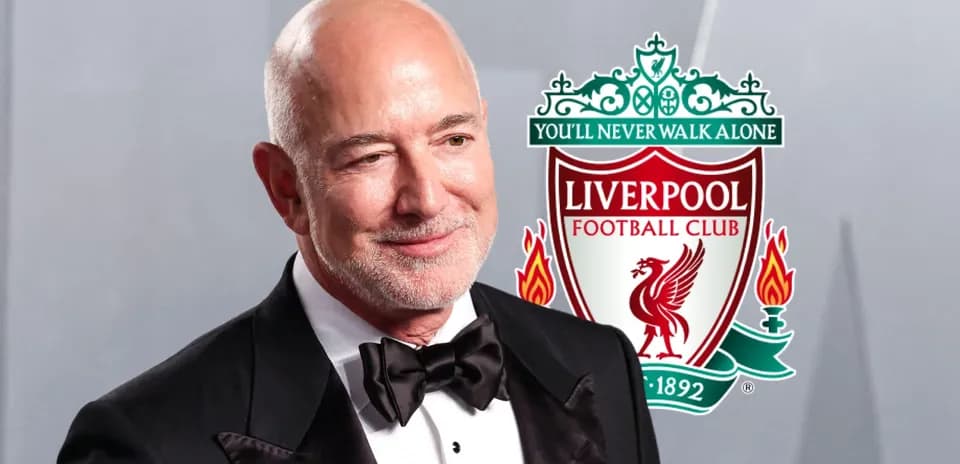 Person in tuxedo with Liverpool FC logo backdrop