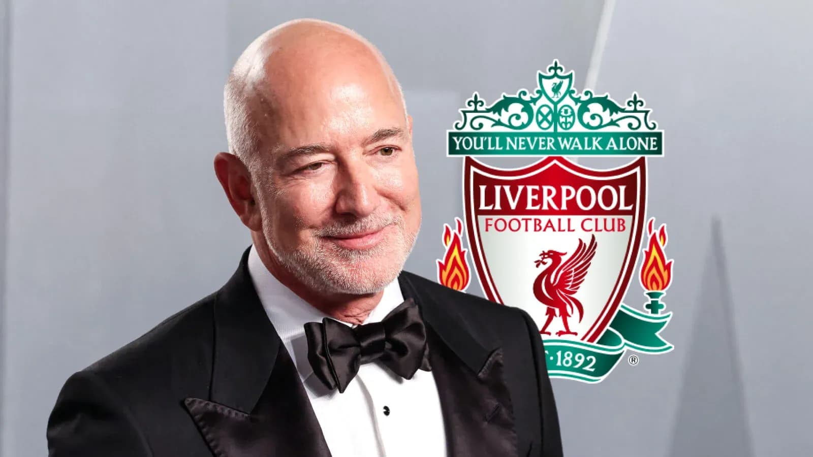 Person in tuxedo with Liverpool FC logo backdrop
