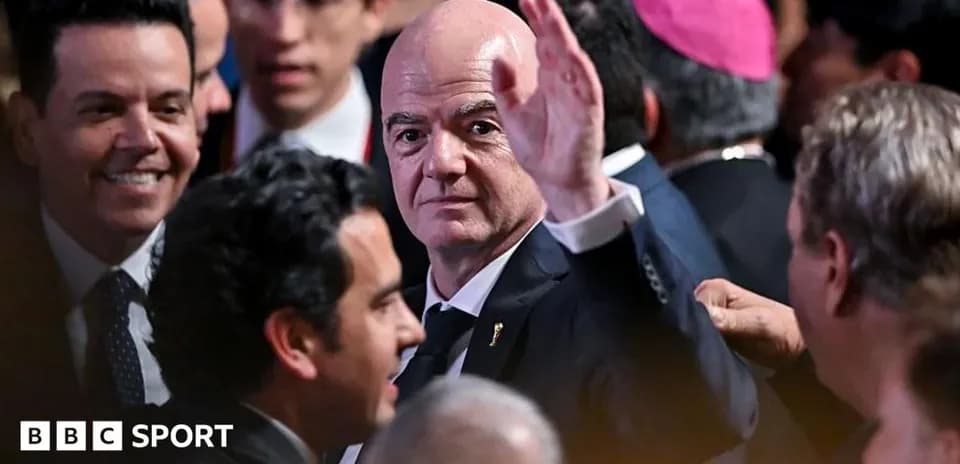 Gianni Infantino waving at an event surrounded by people