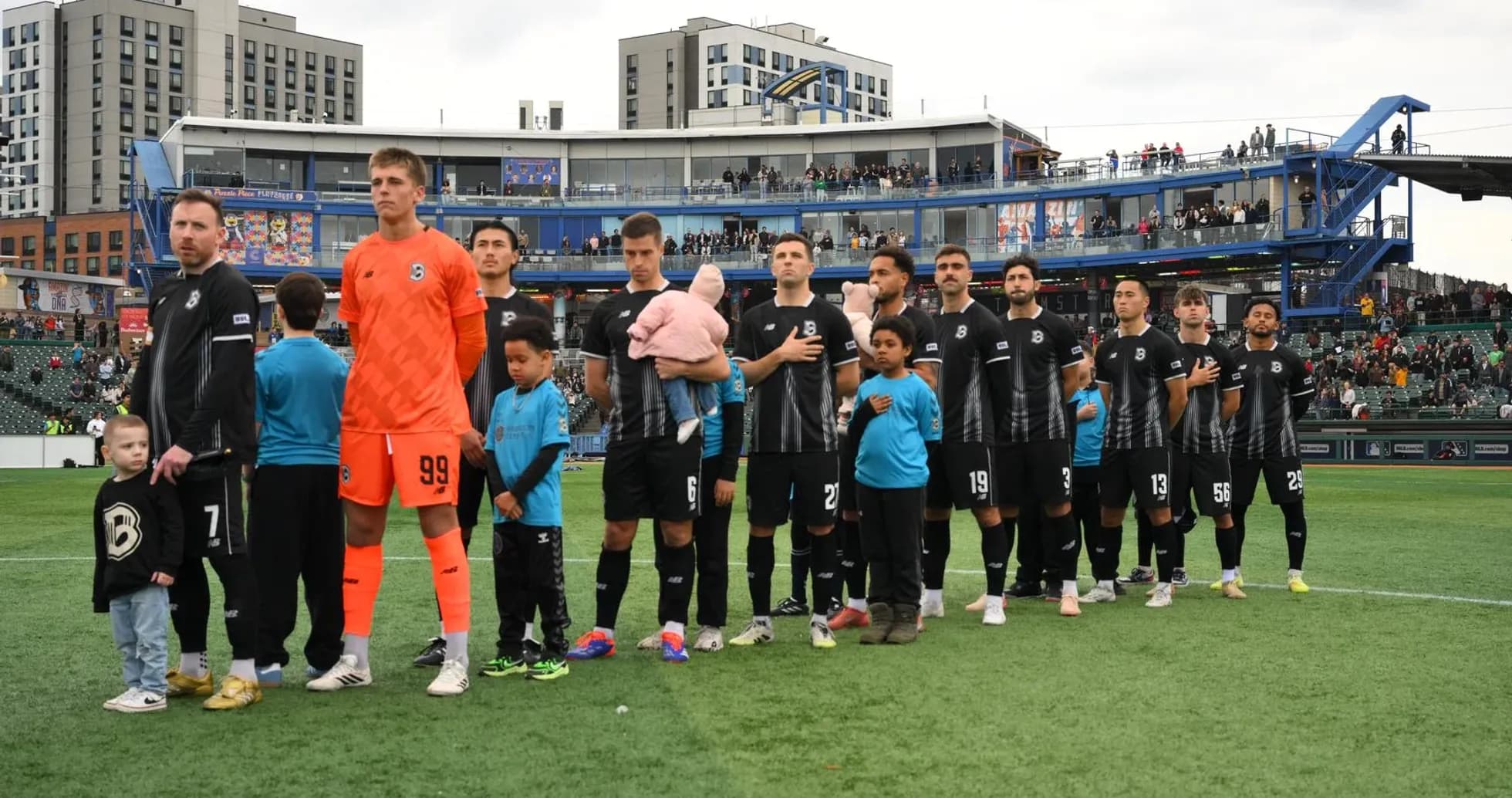 Players standing for national anthem before match