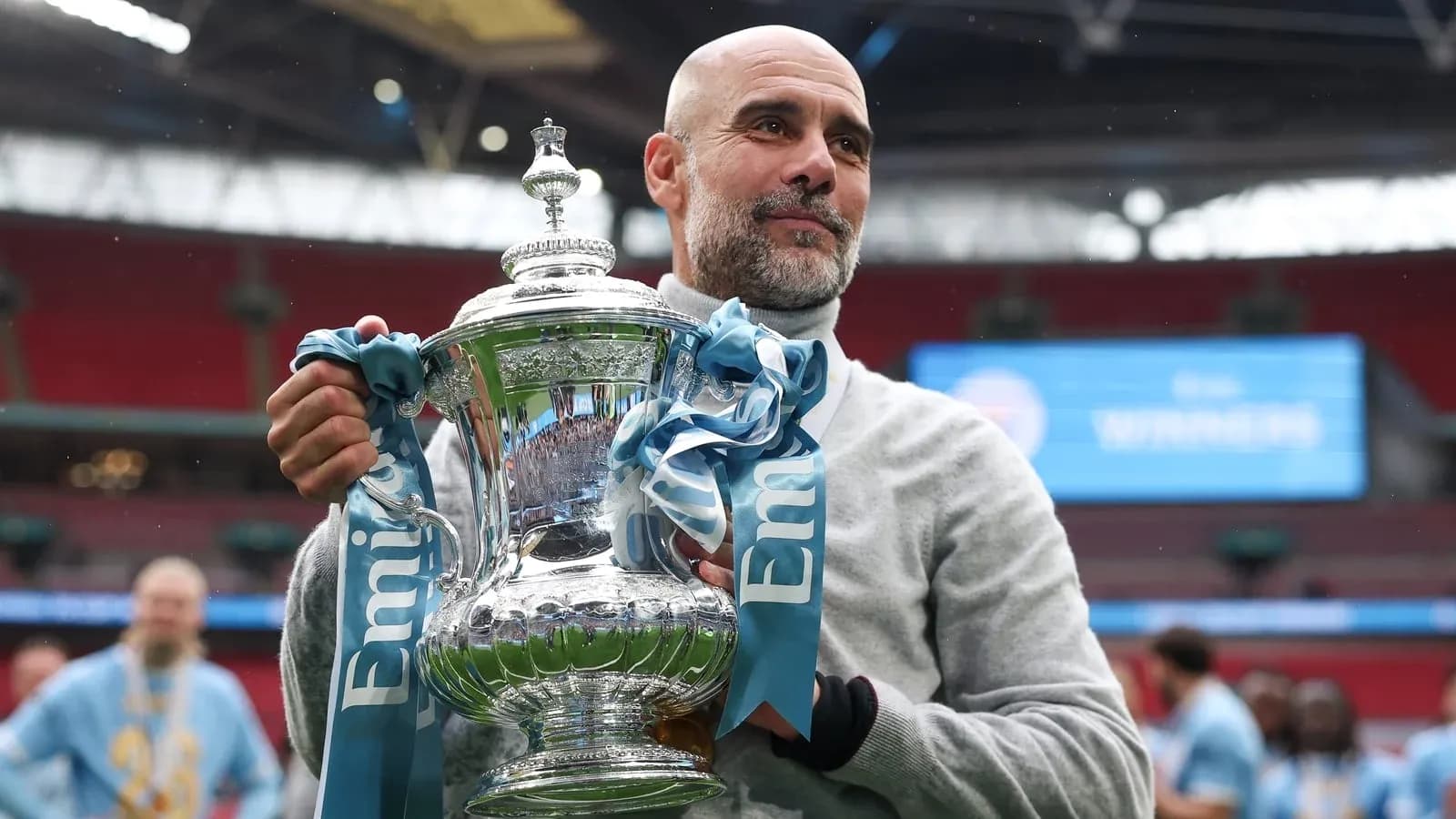 Coach holding trophy after winning match